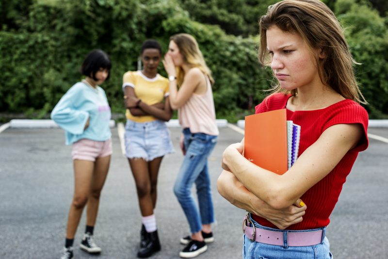 Caucasian woman being bullying from other girls