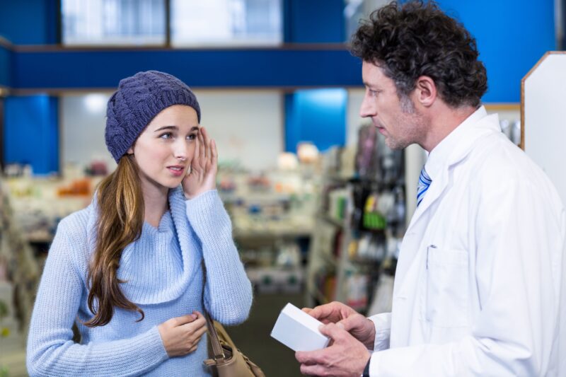 Pikwizard Pharmacist Assisting The Box Of Medicine To Customer