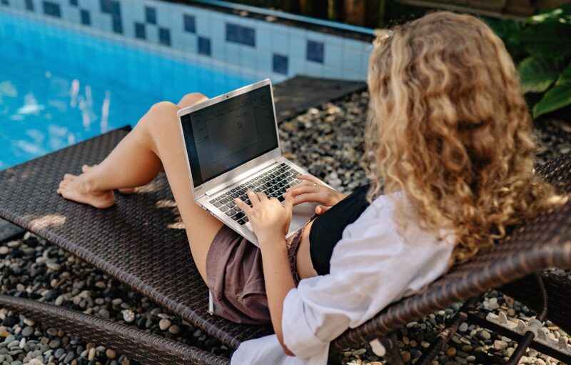 Woman With Laptop At Pool